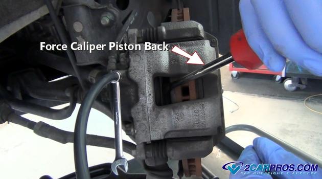 push brake caliper piston back into place